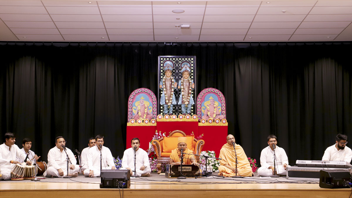 Sadhus and youths sing kirtans in the assembly