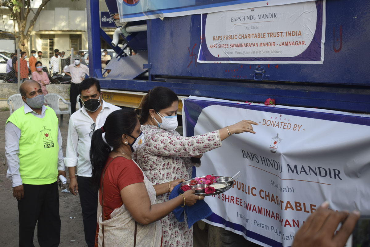 A community leader performs pujan of the container