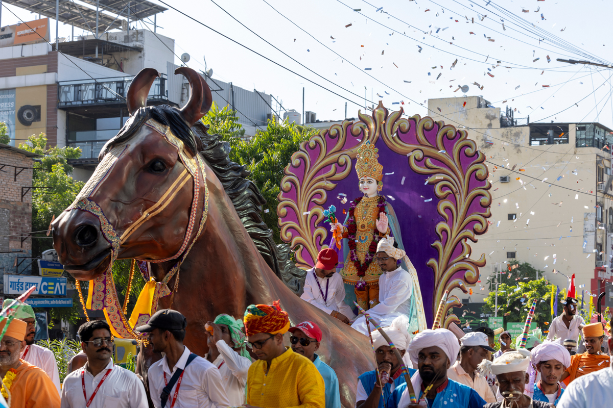 Shri Ghanshyam Maharaj on a decorative rath (chariot)